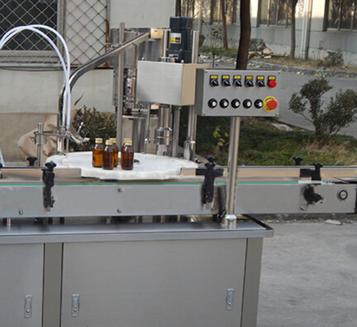vials capping machine מכונת מכסים לצנצנות זכוכית.jpg